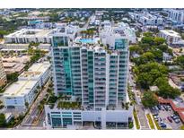 Stunning aerial view of a high-rise condo building with a rooftop pool and panoramic city views at 540 N Tamiami Trl # 802, Sarasota, FL 34236