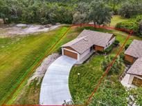 Charming single-story home with a long driveway, landscaped yard, and surrounded by lush greenery at 1817 Curry Ave # 57, Nokomis, FL 34275