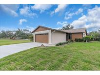Charming single-story home featuring an attached two car garage, a well-manicured lawn, and beautiful landscaping at 1817 Curry Ave # 57, Nokomis, FL 34275