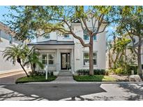 Charming two-story home featuring manicured landscaping, a welcoming porch, and a well-maintained front yard at 1746 Stapleton St, Sarasota, FL 34239