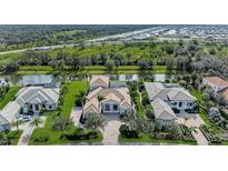 Stunning aerial view of luxurious homes along a scenic canal in a well-maintained community at 3360 Founders Club Dr, Sarasota, FL 34240