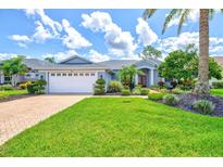 Charming single-story home with well-manicured lawn and lush landscaping at 7453 Featherstone Blvd, Sarasota, FL 34238
