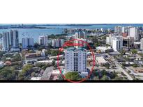 Aerial view of a high-rise condo building on the water, offering a glimpse of prime real estate and waterfront lifestyle at 505 S Orange Ave # 501, Sarasota, FL 34236