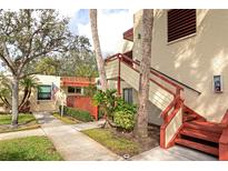Condo exterior showcasing the entry staircase and mature landscaping at 535 Spring Lakes Blvd, Bradenton, FL 34210