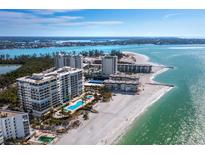 Stunning aerial view of beachfront condos with pools and pristine white sand along the Gulf Coast at 1800 Benjamin Franklin Dr # B408, Sarasota, FL 34236