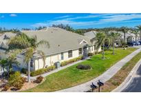 Charming single-story home with lush landscaping, well-manicured lawn, and a quaint walkway at 9367 Hawk Nest Ln, North Port, FL 34287