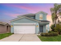 Charming two-story home with attached two car garage and well-manicured lawn at 2347 Richwood Pike Dr, Ruskin, FL 33570