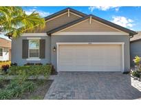 Charming single Gathering home featuring a two-car garage and beautifully landscaped front yard at 3747 Laughing Dove Ave, Sun City Center, FL 33573