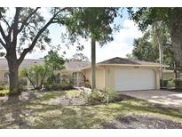 Charming single-story home featuring a two-car garage and tropical landscaping at 5244 Marsh Field Rd # 6, Sarasota, FL 34235