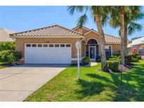 Charming home with a well-manicured lawn and mature palm trees in a desirable neighborhood at 1364 Berkshire Ct, Venice, FL 34292