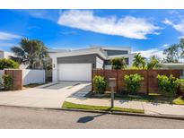 Contemporary home featuring a two-car garage, unique landscaping, and a modern gray and white color scheme at 2254 Hawthorne St, Sarasota, FL 34239