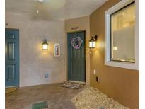 Inviting condo entrance with a decorative wreath on the dark green door and ambient lighting at 4007 Overture Cir, Bradenton, FL 34209