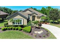 Beautiful single-story home with a well-manicured front yard, lush landscaping, and a long driveway at 5304 96Th E St, Bradenton, FL 34211