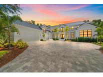 Stunning two-story home featuring a spacious driveway, well-manicured landscaping, and a grand entrance at 656 Tropical Cir, Sarasota, FL 34242
