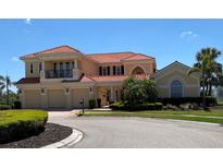 Stunning two-story home featuring a red tile roof, three-car garage, and beautiful landscaping at 273 Portofino Dr, North Venice, FL 34275