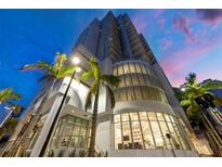Modern high-rise condo building featuring contemporary architecture, sleek lines, and expansive glass windows and balconies at 301 Quay Commons # 1411, Sarasota, FL 34236