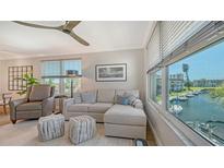 Bright living room with a comfortable couch and a scenic view of the waterfront at 4320 Falmouth Dr # 301, Longboat Key, FL 34228