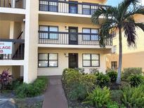 Inviting condo with a well-maintained exterior, complete with lush landscaping and a mature palm tree, offering curb appeal at 315 30Th W Ave # 101B, Bradenton, FL 34205