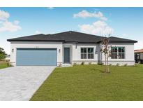 Beautiful single-story home with a well-manicured lawn, blue garage door, and bright white paint at 514 Santiguay St, Punta Gorda, FL 33983