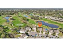 Aerial view of a two-story home located on a cul-de-sac overlooking a golf course and pond at 7812 Birdie Bend Way, Sarasota, FL 34241
