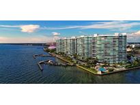 Stunning aerial view of waterfront condos with private boat docks and a refreshing pool at 888 Blvd Of The Arts # 1608, Sarasota, FL 34236