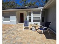 Charming home featuring a brick paved courtyard with seating to enjoy the outdoors at 4553 Linwood St, Sarasota, FL 34232