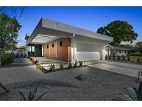 Modern home featuring clean lines, wood accents, and well-maintained landscaping at 2149 Hyde Park St, Sarasota, FL 34239