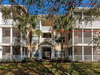 Inviting condo exterior with screened balconies, lush landscaping, and secure entrance in a tranquil community at 4802 51St W St # 1811, Bradenton, FL 34210