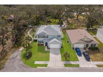 Aerial shot of a two-story home with a well-manicured lawn and mature landscaping, showcasing its desirable curb appeal at 5809 71St E St, Palmetto, FL 34221