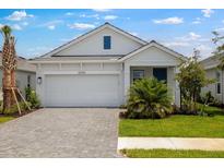 Charming single-Gathering home featuring a two-car garage, lush green lawn, and well-maintained landscaping at 26930 Lark Ct, Punta Gorda, FL 33955