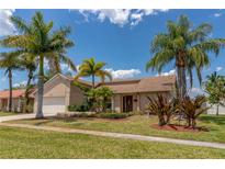 Beautiful single-story home featuring a well-manicured lawn, mature palm trees, and inviting curb appeal at 3739 Kingston Blvd, Sarasota, FL 34238