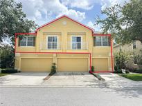 Well-maintained townhome features three garage doors and balconies on second floor at 6768 Breezy Palm Dr, Riverview, FL 33578