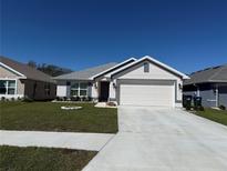 Charming single-Gathering home with a manicured lawn and a two-car garage, perfect for suburban living at 2556 Averland Loop, North Port, FL 34287