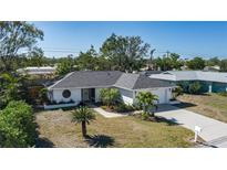 Charming single-story home with a well-maintained lawn and tropical landscaping at 6705 20Th W Ave, Bradenton, FL 34209