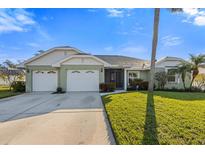 Charming one-story home with attached two-car garage and well-manicured lawn at 1209 89Th Nw St, Bradenton, FL 34209