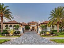 Stunning home featuring lush landscaping, a circular driveway, and a grand entrance at 14733 Como Cir, Lakewood Ranch, FL 34202