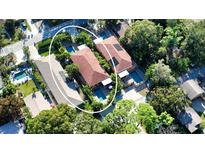 Stunning aerial view of two adjacent homes each featuring private pools and lush tropical landscaping for ultimate privacy at 2047 Roselawn St, Sarasota, FL 34231