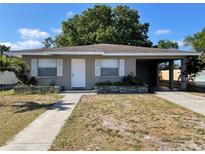 Charming single-story home featuring a covered carport and a walkway leading to the front door at 3305 13Th W Ave, Bradenton, FL 34205