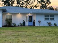 Charming single-story home with a well-maintained lawn and lovely landscaping at 400 Dona Dr, Nokomis, FL 34275