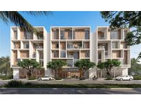 Modern condominium exterior with sleek design, private balconies, and manicured trees at 430 Kumquat Ct # 206, Sarasota, FL 34236