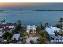 Beautiful waterfront property with stunning views and lush landscaping at 679 Norsota Way, Sarasota, FL 34242