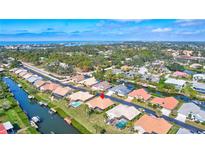 Waterfront neighborhood with beautiful landscaping, private docks, and swimming pools near lush greenery and ocean views at 104 Inlets Blvd # 104, Nokomis, FL 34275