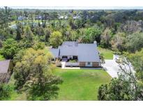 Expansive aerial view of a private home surrounded by lush greenery and mature trees at 3651 Walden Pond Dr, Sarasota, FL 34240