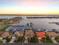 Stunning waterfront homes with private docks along a tranquil canal at sunset at 1007 3Rd E St, Palmetto, FL 34221