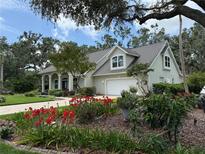 Charming single-Gathering home featuring a well-manicured lawn and a two-car garage at 3301 River Woods Dr, Parrish, FL 34219