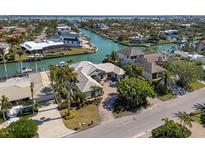 Stunning waterfront home with lush landscaping, private dock, and serene canal views at 355 W Royal Flamingo Dr, Sarasota, FL 34236