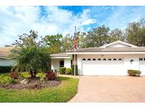 Charming single-story home featuring a well-manicured lawn and a two-car garage, perfect for suburban living at 5642 Garden Lakes Dr, Bradenton, FL 34203
