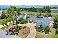Well-maintained single-Gathering home on a landscaped lot with circular driveway and serene water views at 3837 Torrey Pines Blvd, Sarasota, FL 34238