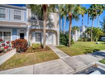Charming townhome with well-kept lawn, sidewalk, and beautiful palm trees in the front yard at 4717 Sabal Key Dr, Bradenton, FL 34203