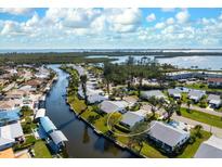 Stunning aerial view of a waterfront community, showing canals, lush greenery and access to the open bay at 4721 Mount Vernon Dr, Bradenton, FL 34210